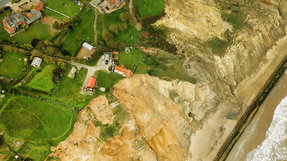 farmhouse hanging over cliff edge SWNS