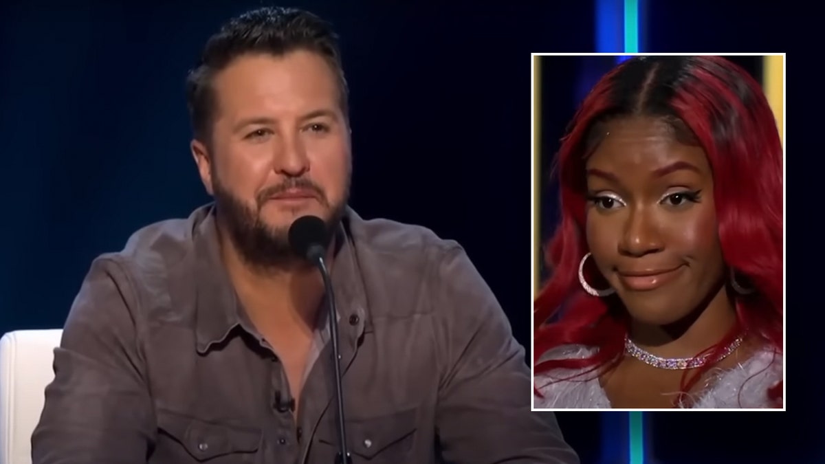Luke Bryan in a brown/grey shirt sits behind the American Idol judges desk inset contestant Madaí ChaKell looks displeased on stage
