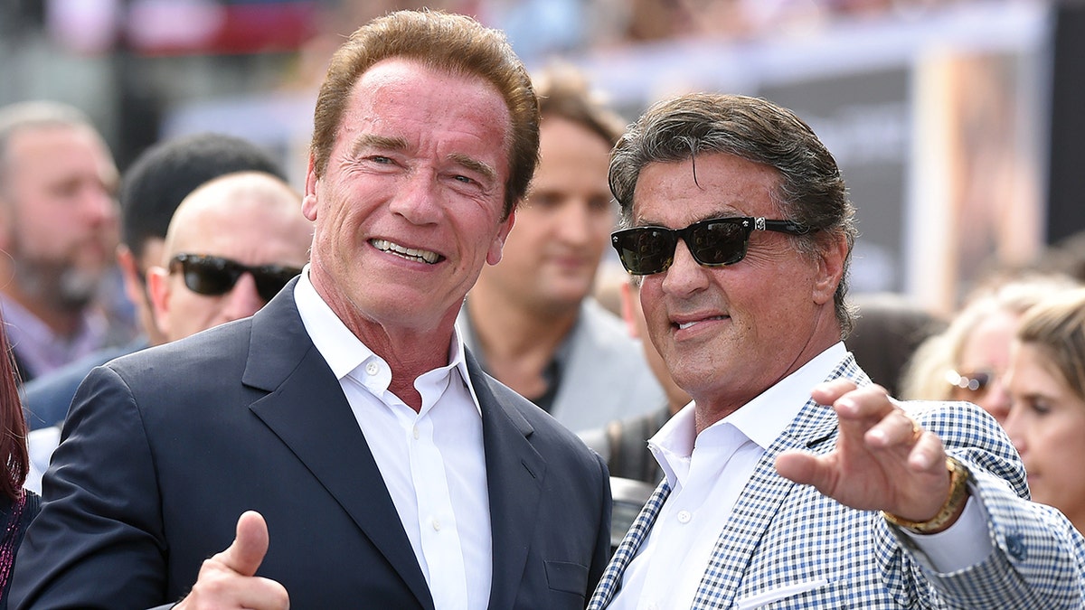 Sylvester Stallone gives a thumbs up as he poses with Sylvester Stallone in sunglasses