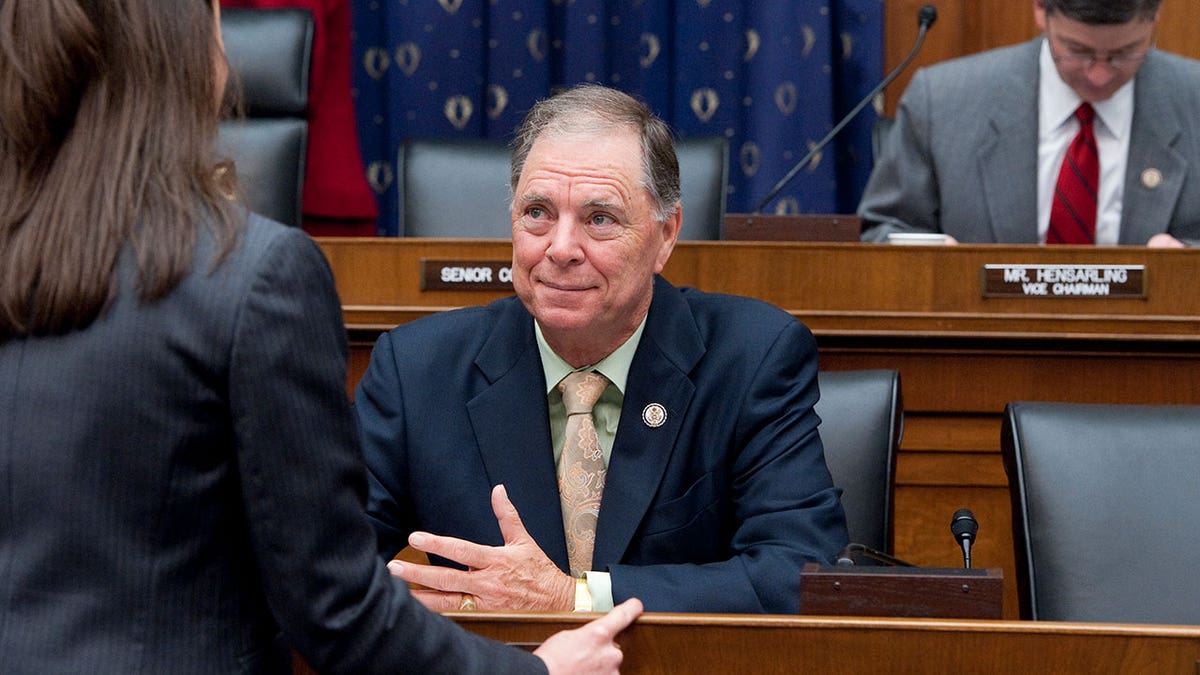 Rep. Bill Posey smiles portion    seated during hearing.