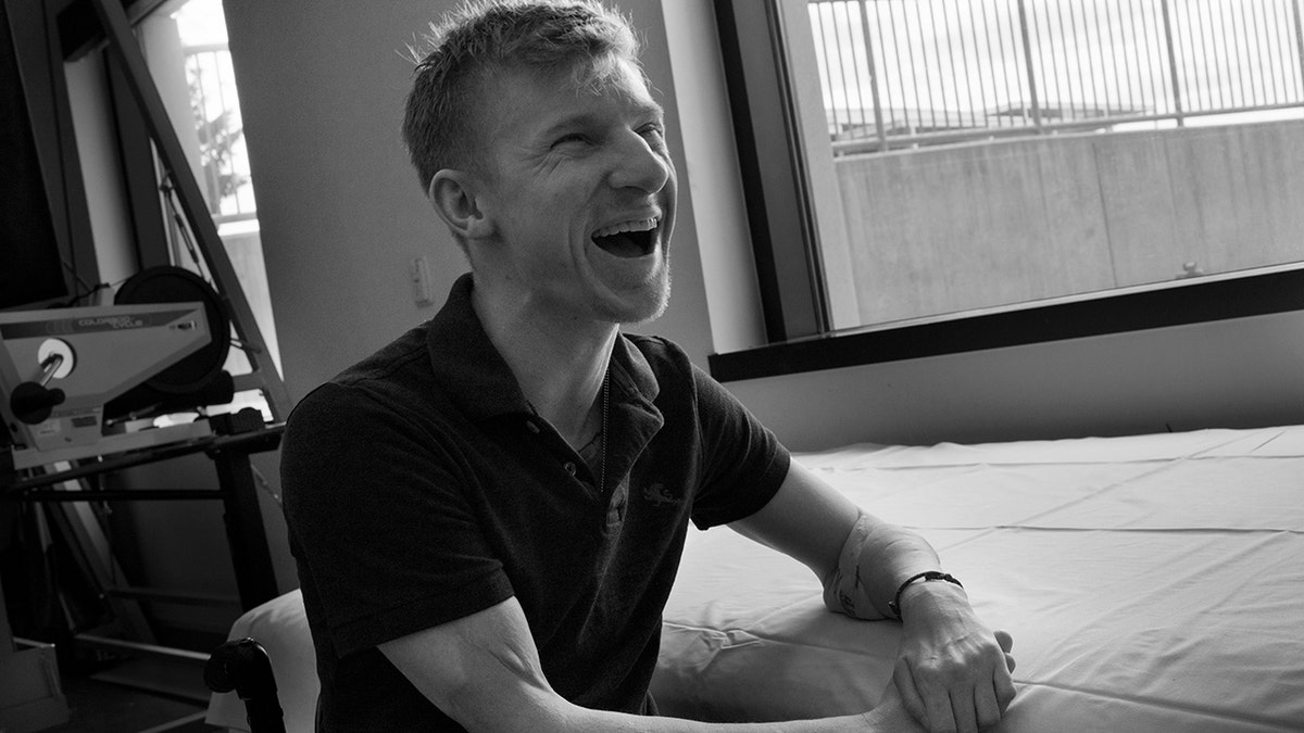 A black and white photo of Brendan Marrocco laughing.