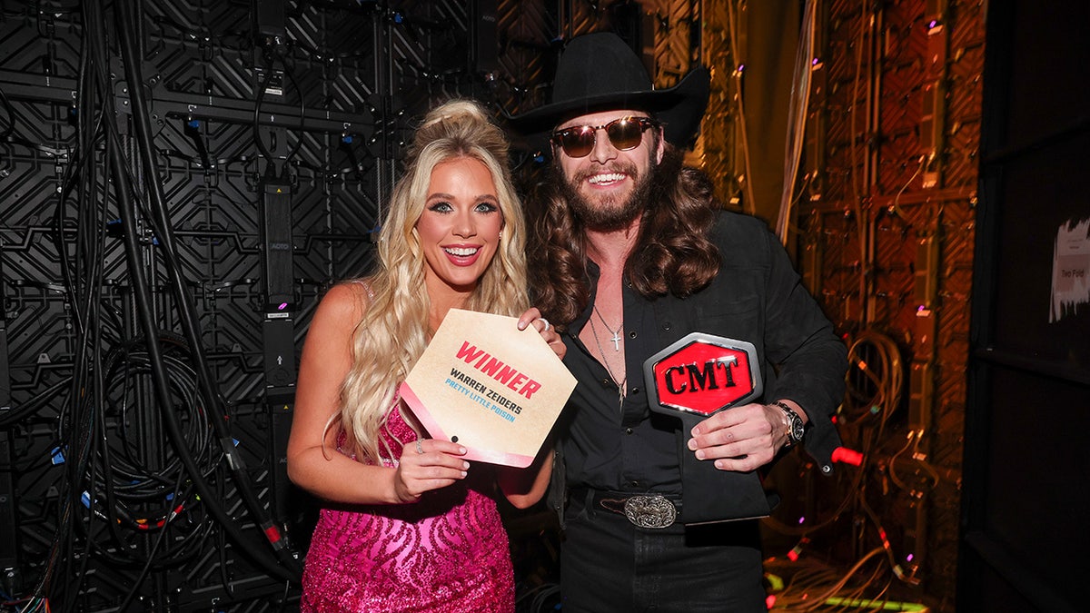 A estrela country Warren Zeiders sorri ao lado de Megan Moroney no CMT Music Awards