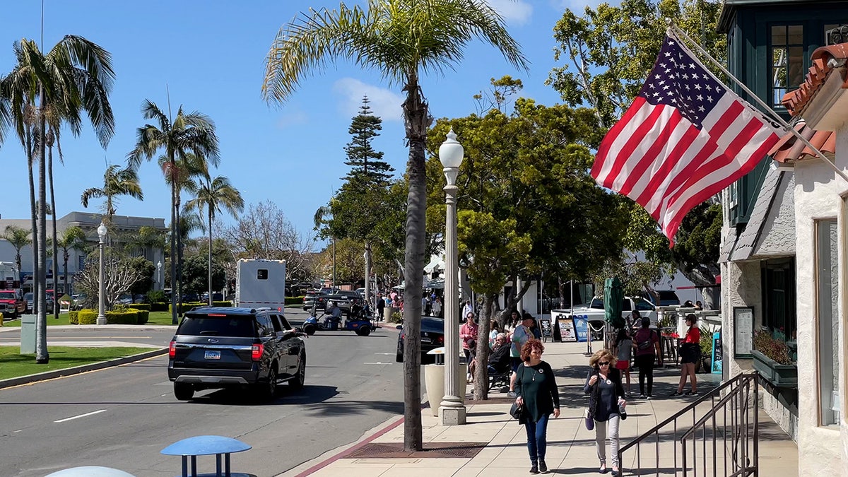 People walk on sidewalk in Coronado, California