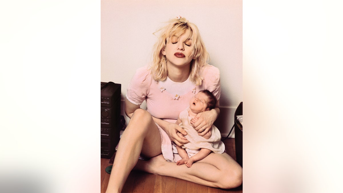 Courtney Love carrying Francis Bean as a baby