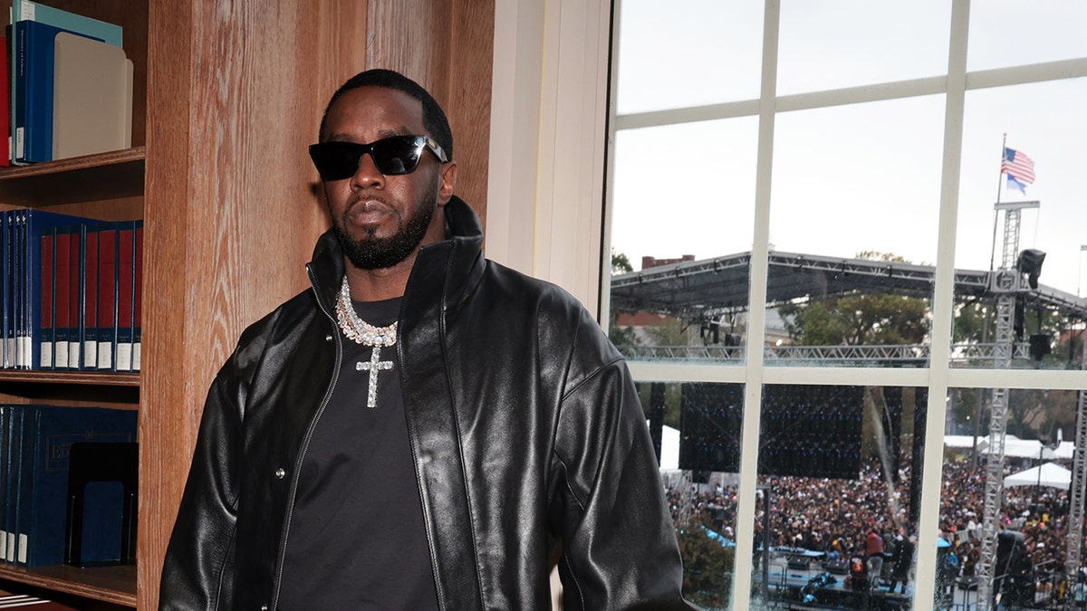 Diddy wears a leather jacket in a library before a concert