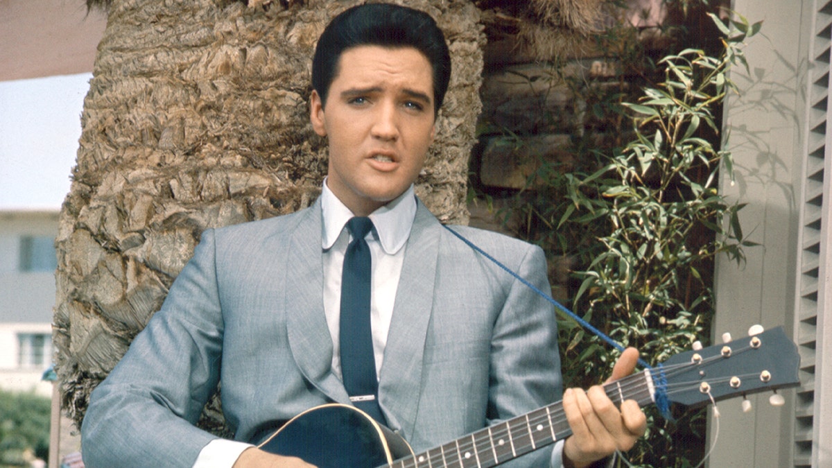 Elvis Presley playing the guitar