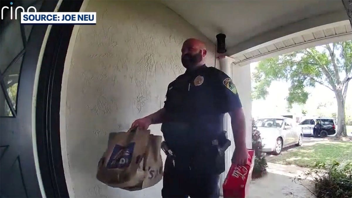 Officer brings groceries to FL home