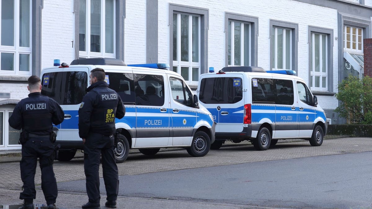 Police officers guidelines adjacent their vans extracurricular a building that is being searched successful Solingen, Germany