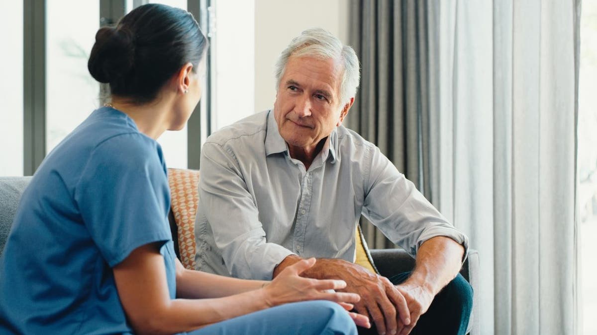 Older man speaking with doctor