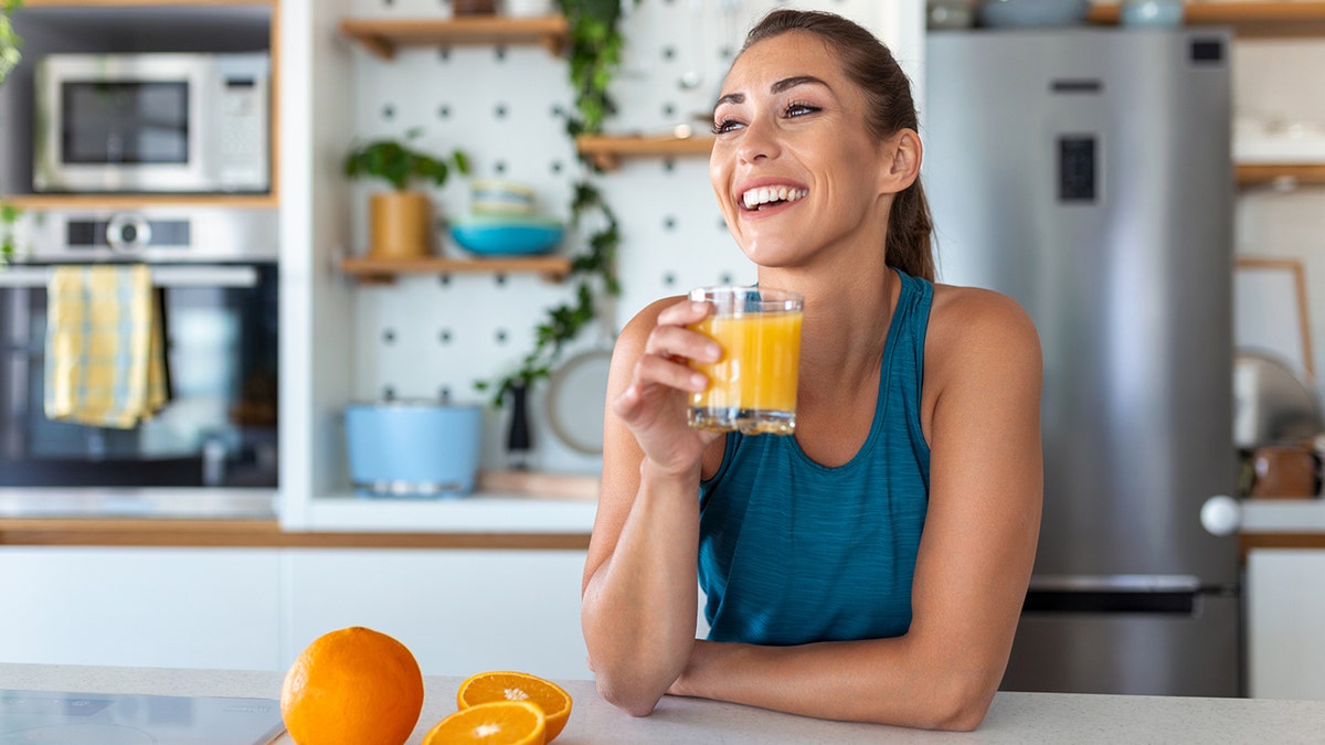 woman drinking orange juice