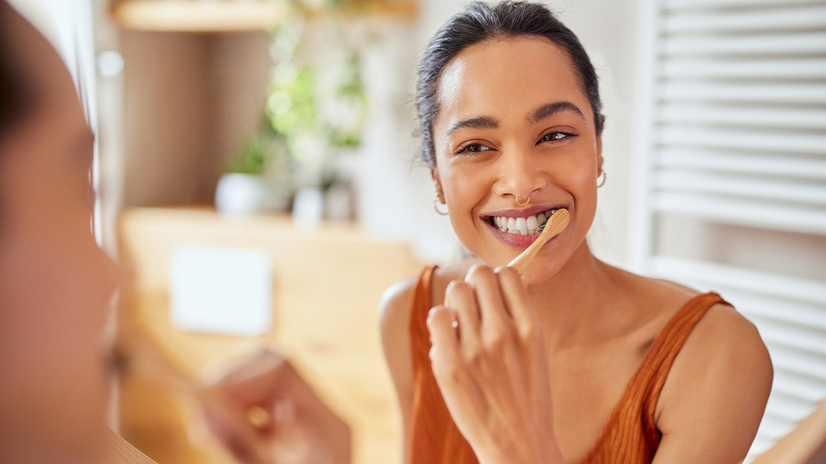 woman brushes teeth