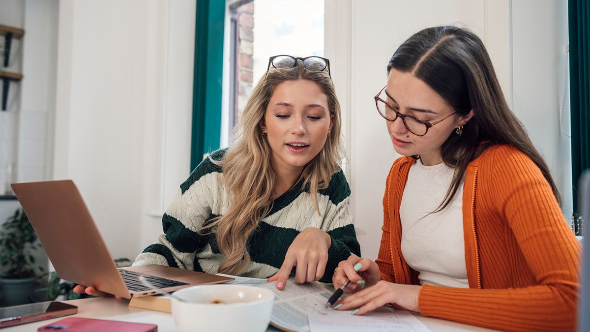 female gen z college students work on a project