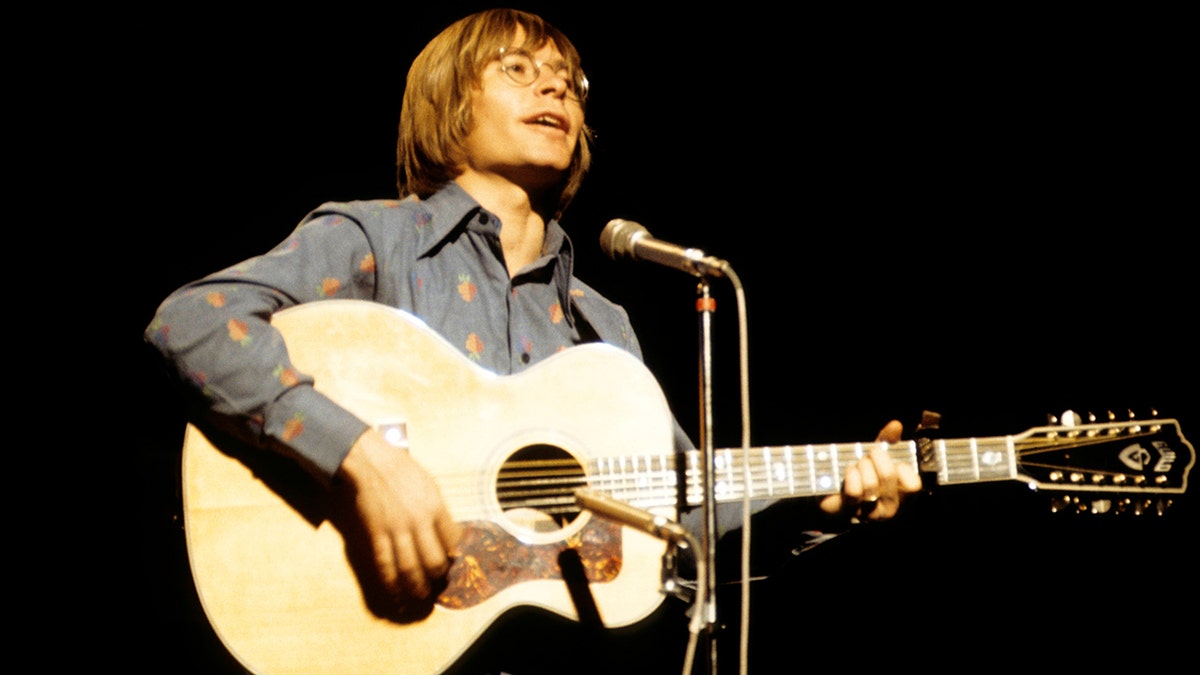 John Dever performing on stage in 1974