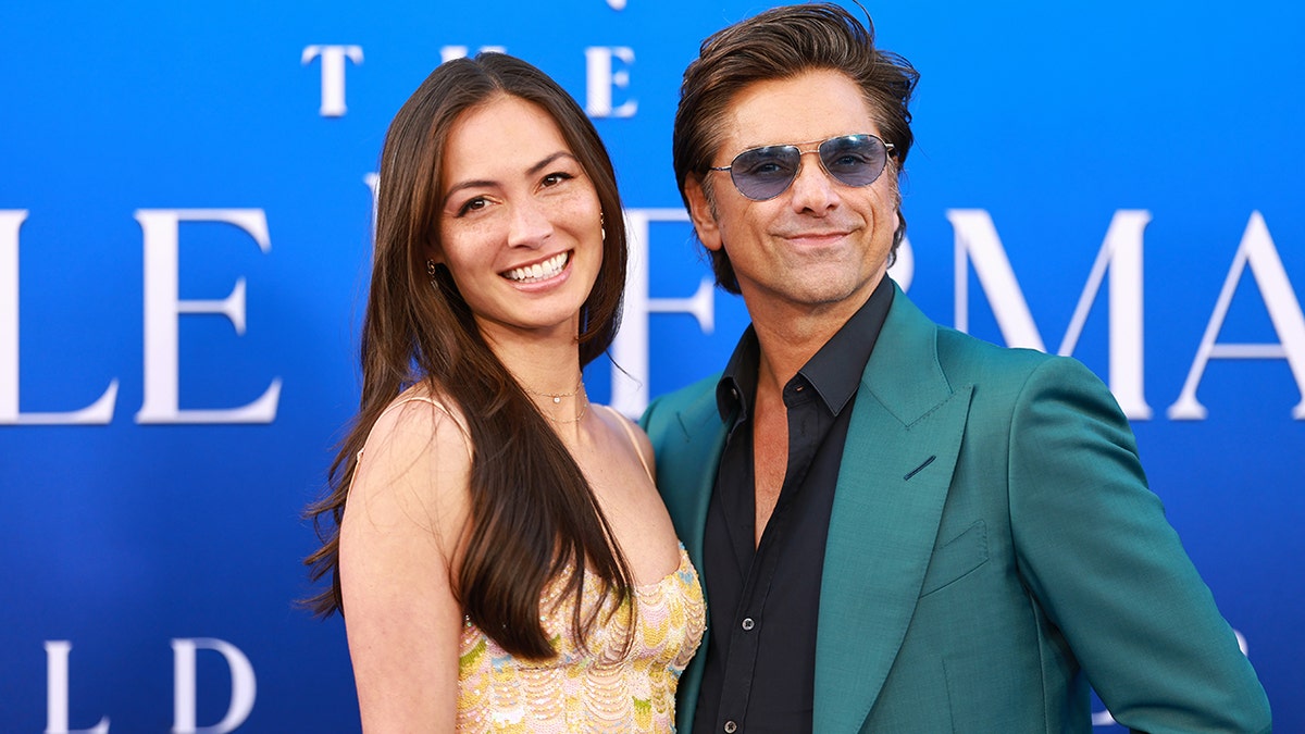 John Stamos and Caitlin McHugh at "The Little Mermaid" premiere