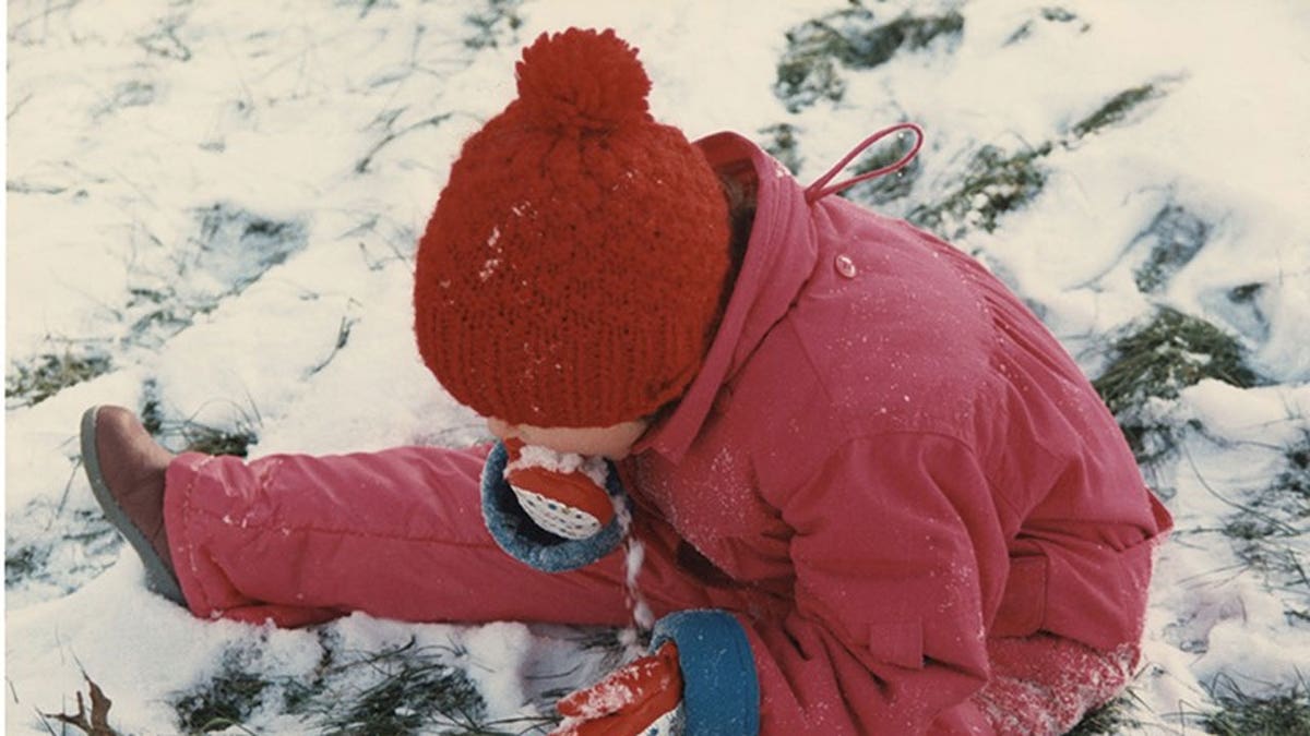 Kid eating snow near coldwater creek