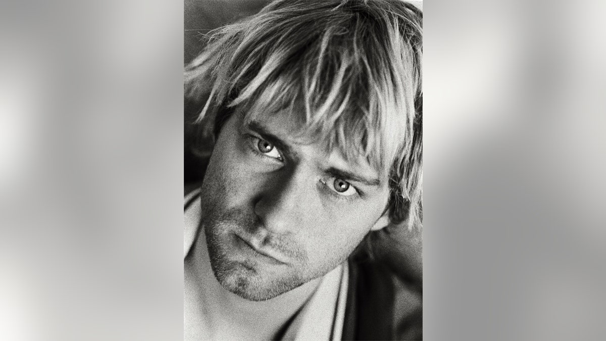 A black and white close up photo of Kurt Cobain