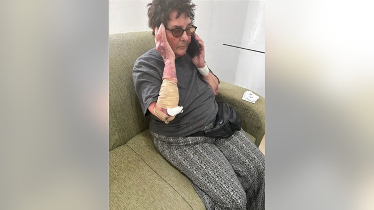 Julie Lenkoff, 80, is pictured here while she was stranded on an African island and on the phone with her family in the US after a South Carolina family took care of her.