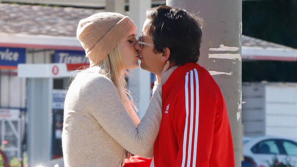 A photo of Maggie Sajak kissing Ross McCall