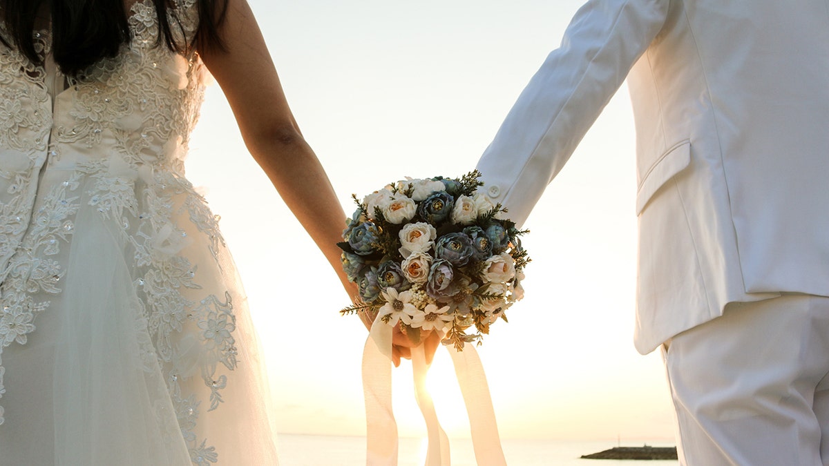 Bride and groom holding hands