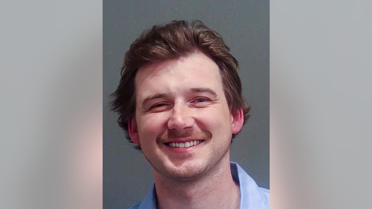 Morgan Wallen smiling in 2024 mugshot