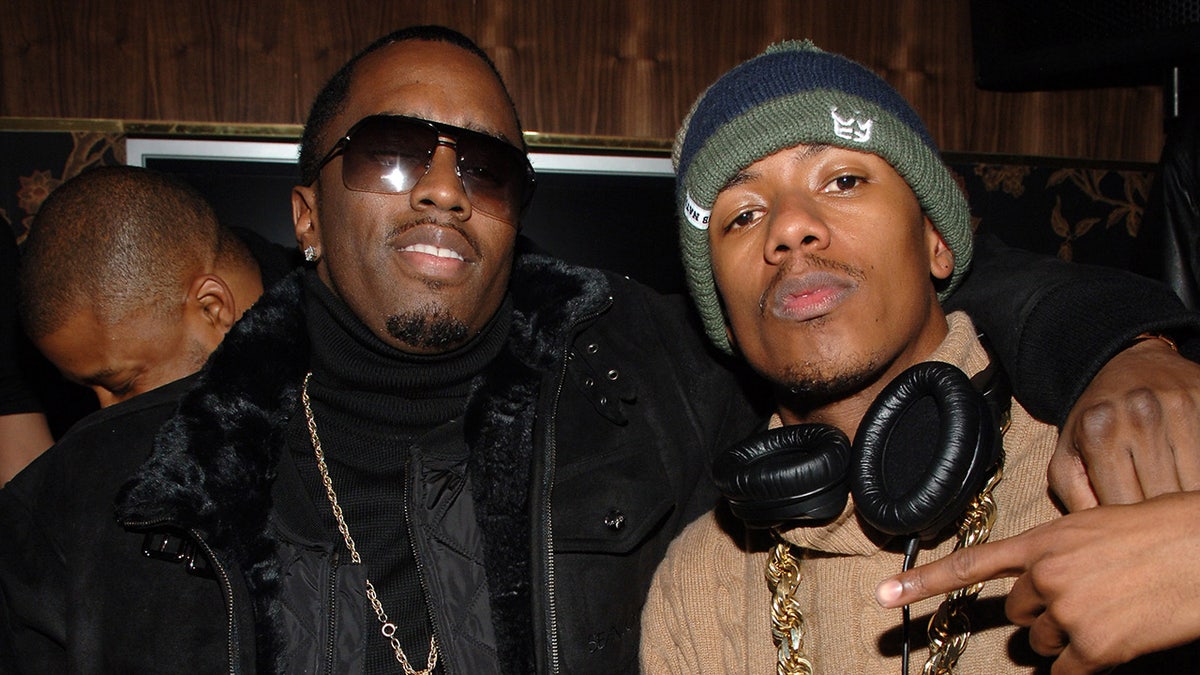 Nick Cannon sports headphones around his neck for photos with Diddy in Park City.