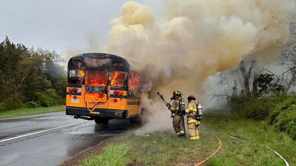 firefighters fighting flames on school bus