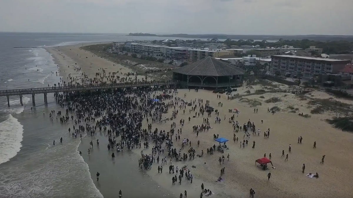 Aerial drone footage showing a packed beach of Tybee Island, Georgia, which has a population of 3,000. 