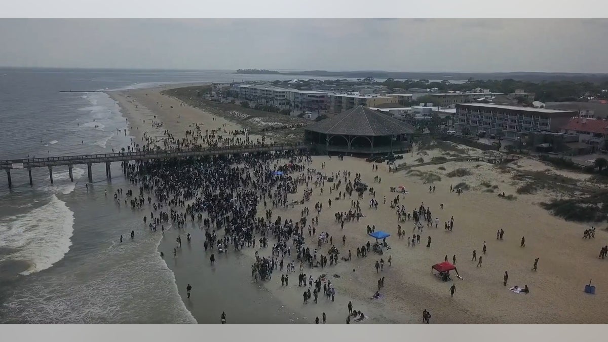 Aerial drone footage showing a packed beach of Tybee Island, Georgia, which has a population of 3,000. 