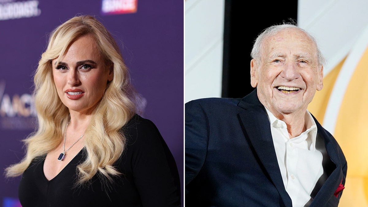 Rebel Wilson successful a achromatic dress looks straight into nan camera connected nan carpet divided Mel Brooks successful a achromatic suit sits connected stage