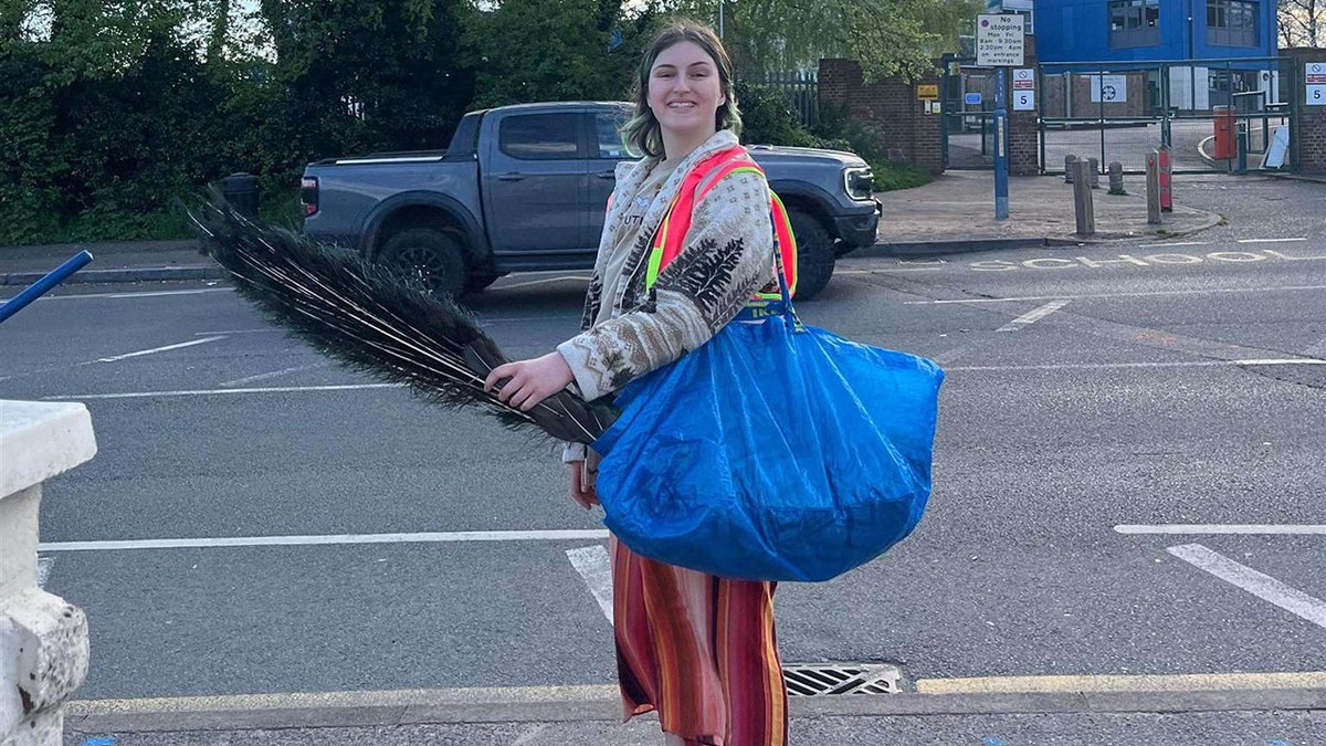 Ciara O'Hare rescuing noisy Peacock SWNS