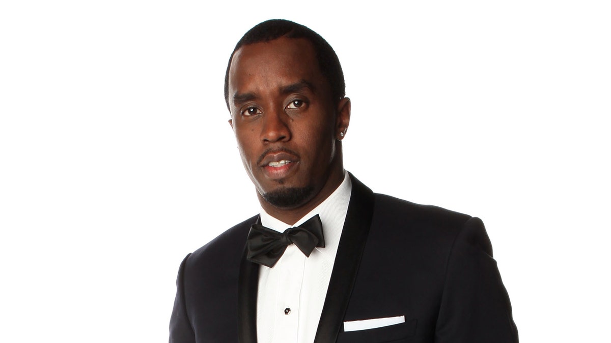 Rapper Diddy wears black suit with bow tie.