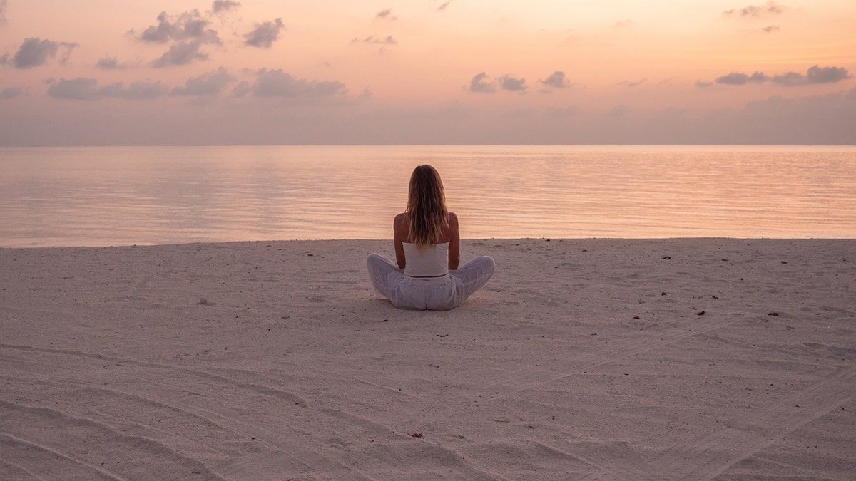 woman sitting alone on the beach