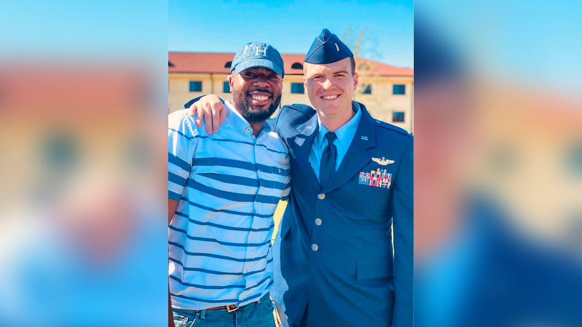 Allen Beachem stands next to someone in a military dress uniform