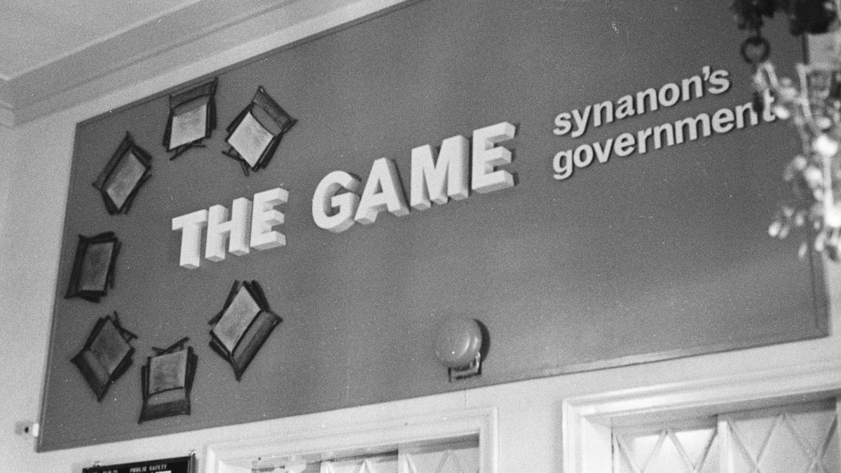 A sign that reads, 'The Game' and 'Synanon Government'
