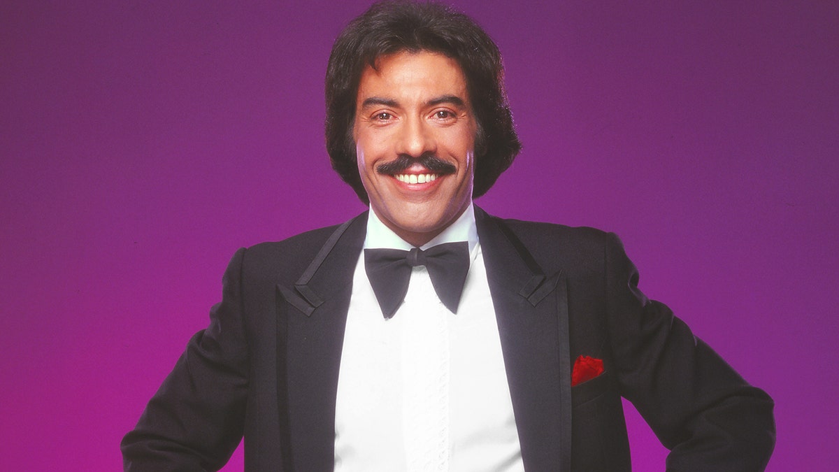 Tony Orlando in 1981, standing in front of a purple background
