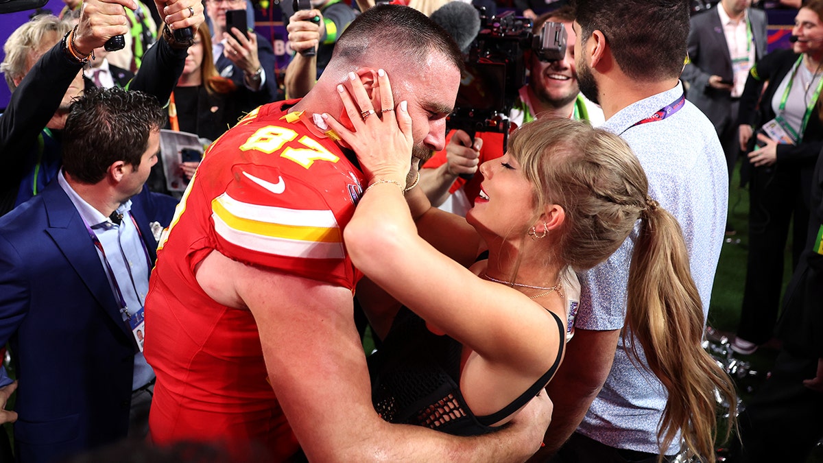 Taylor Swift and Travis Kelce hugging after the Super Bowl.