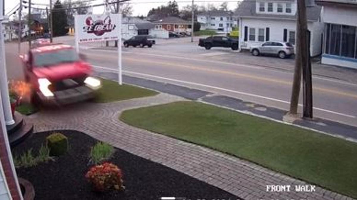 Truck speeding in front of ice cream parlor 