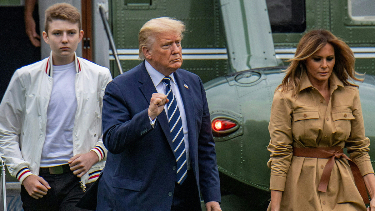 Barron Trump, left, leaving Marine One pinch President Trump and first lady
