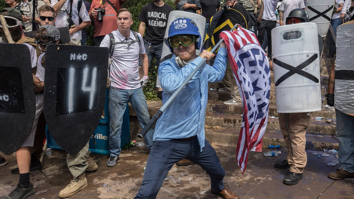 man astatine  Unite the Right rally wields flagpole arsenic  weapon