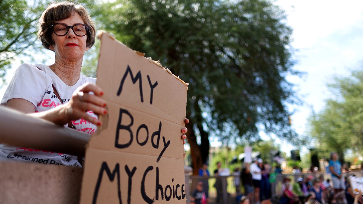 Arizona female holds pro-choice sign