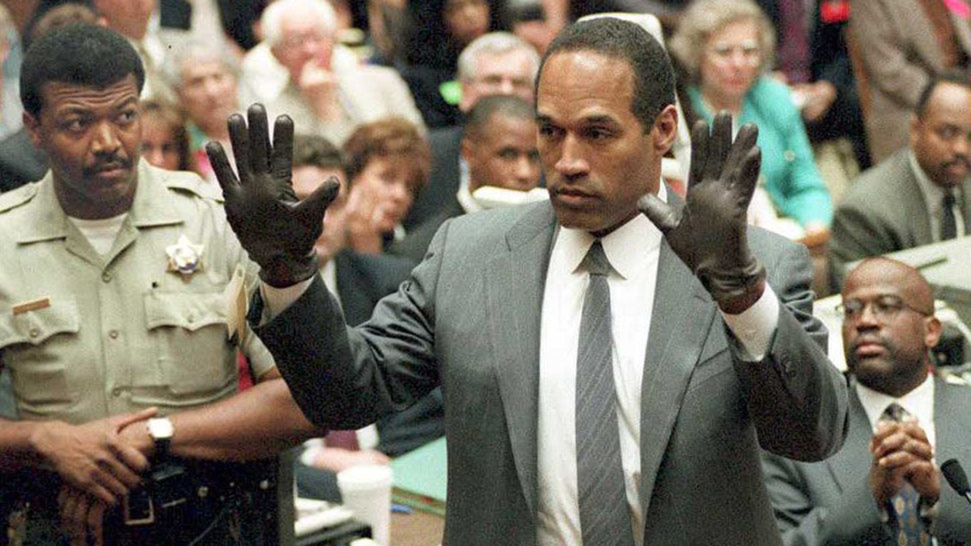 O.J. Simpson shows the jury a new pair of Aris extra-large gloves, similar to the gloves found at the Bundy and Rockingham crime scene