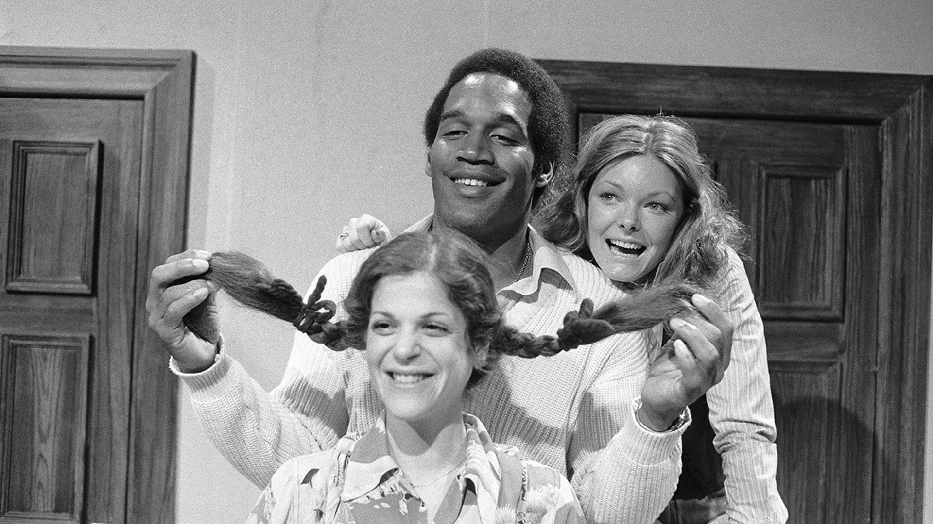 O.J. Simpson poses alongside Gilda Radner’s and Jane Curtin