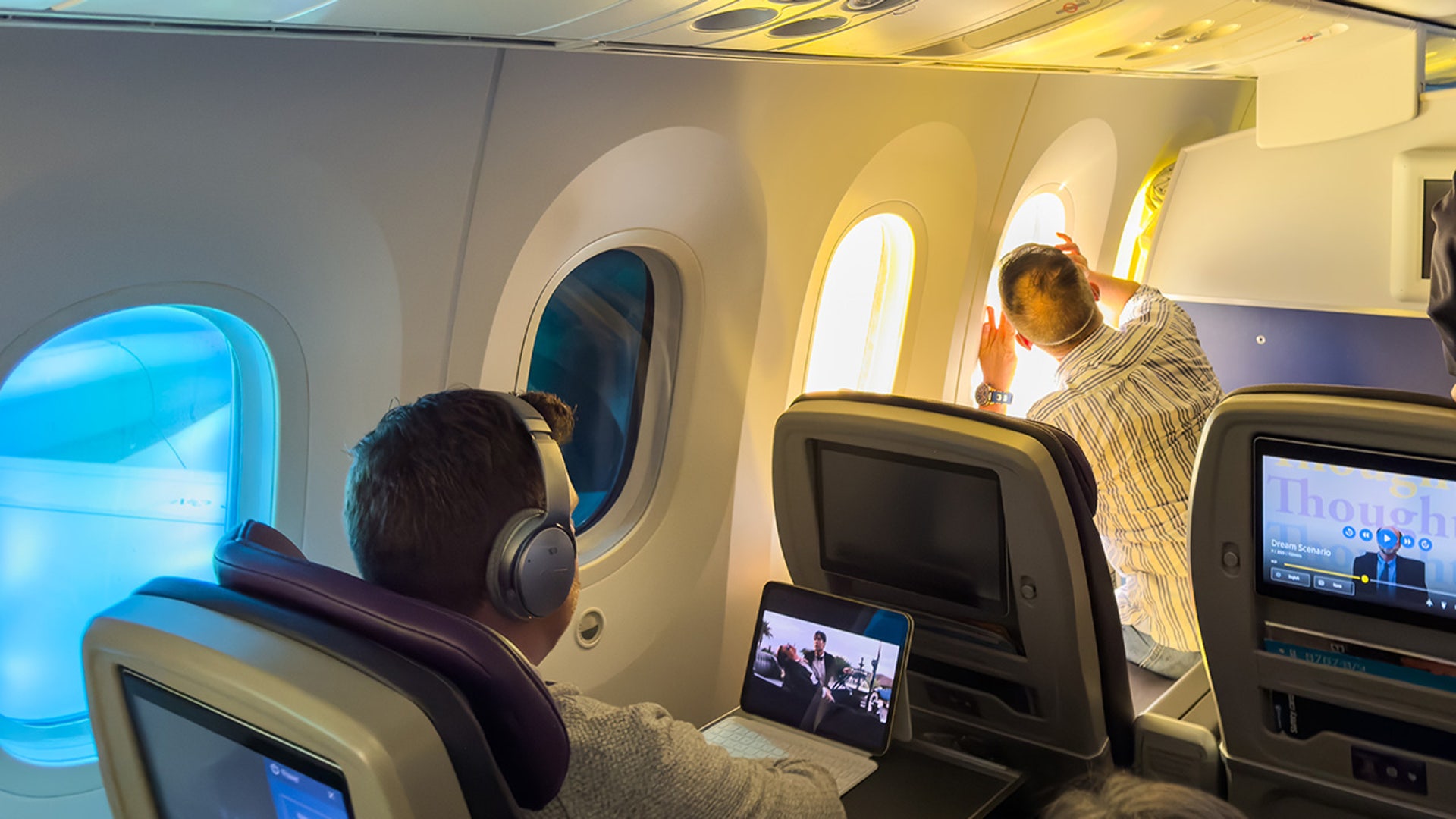People on a flight view a partial eclipse on the left side of the aircraft flying from New Jersey to Los Angeles