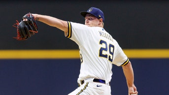 Brewers pitcher suffers concussion after fainting from food poisoning