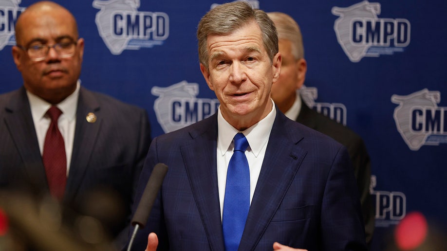 North Carolina Governor Roy Cooper speaks at a press conference in Charlotte