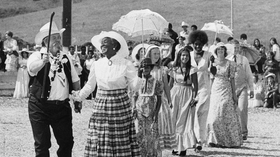 Charles Dederich, founder of Synanon, and wife Betty smile as they lead a wedding parade at the Synanon Wedding Festival August 6, 1972.