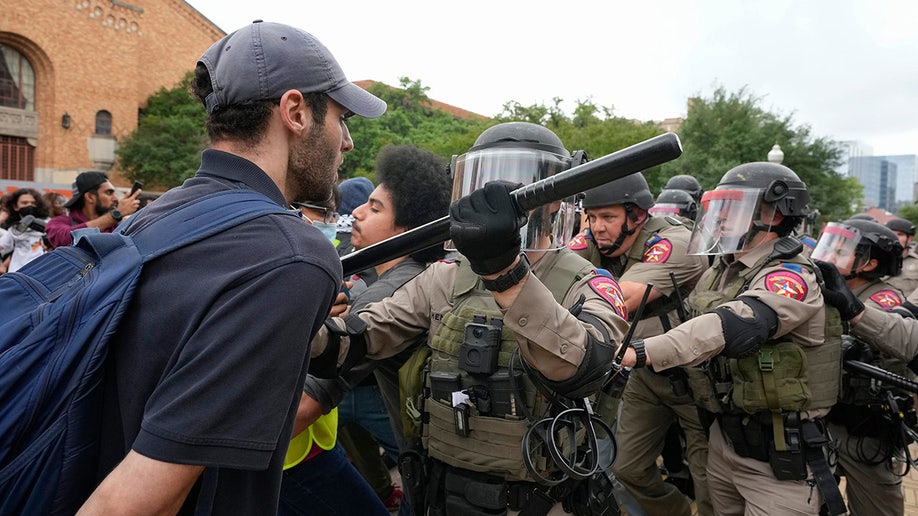 State troopers in riot gear try to break up a pro-Palestinian protest