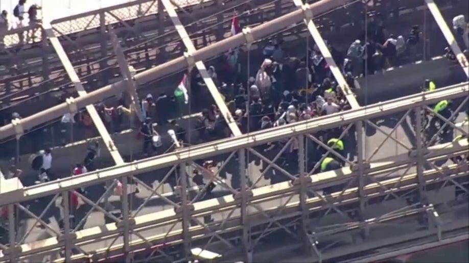 Police trying to stop anti-Israel agitators on the Brooklyn Bridge in NYC