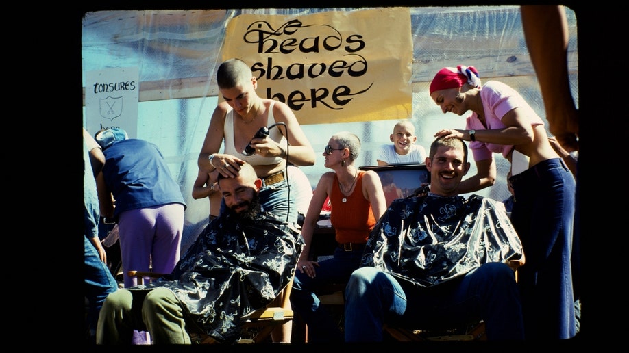 Synanon members shave their heads.