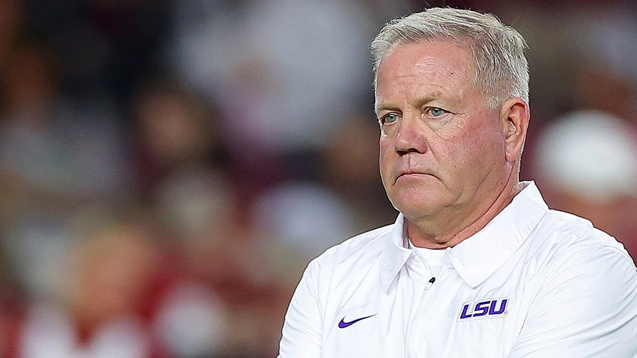 LSU’s Brian Kelly says if school wants team on field for national anthem, ‘we’re going to proudly stand’